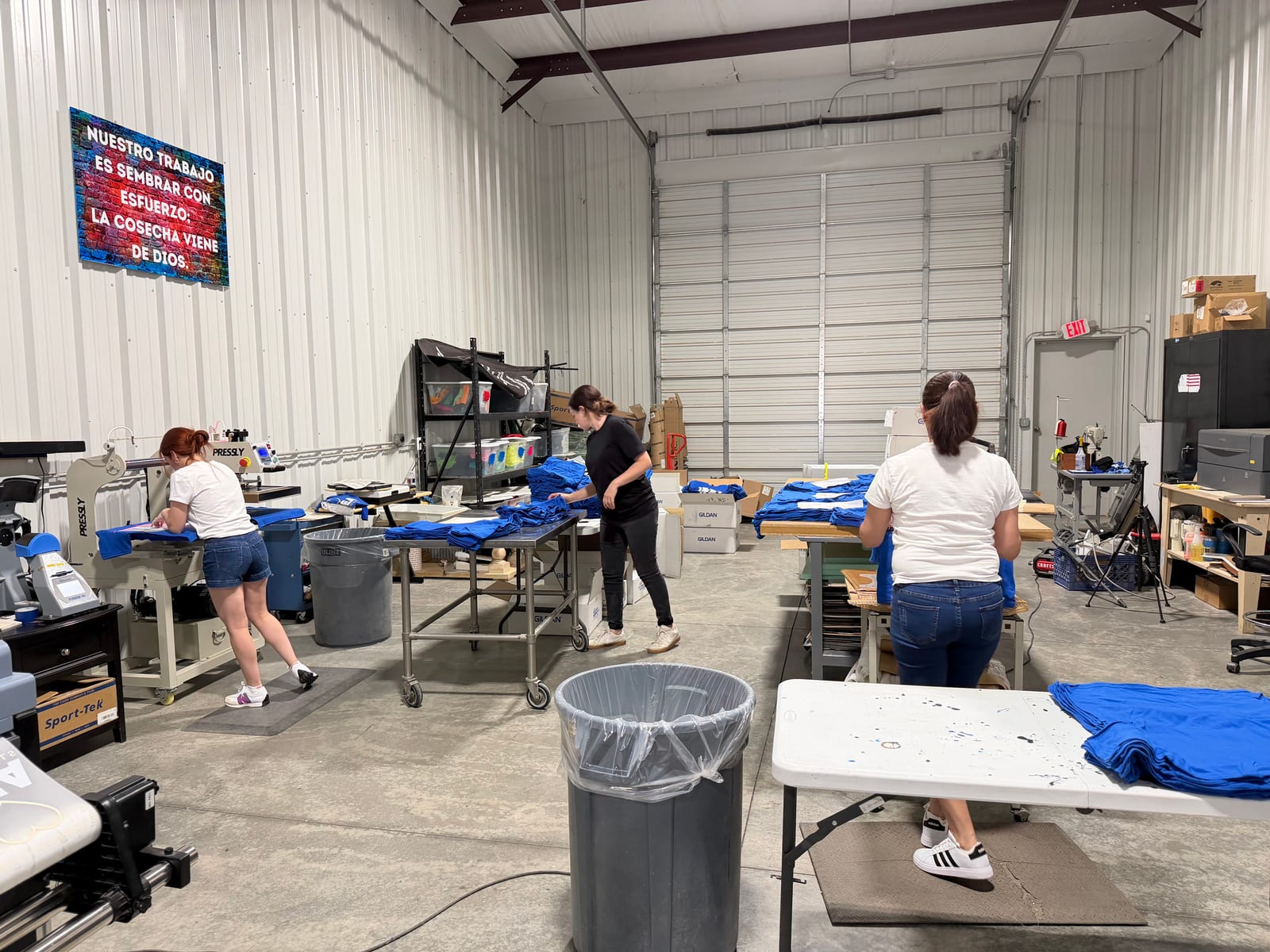 Staff working a bulk apparel run on the Print A Vision production floor