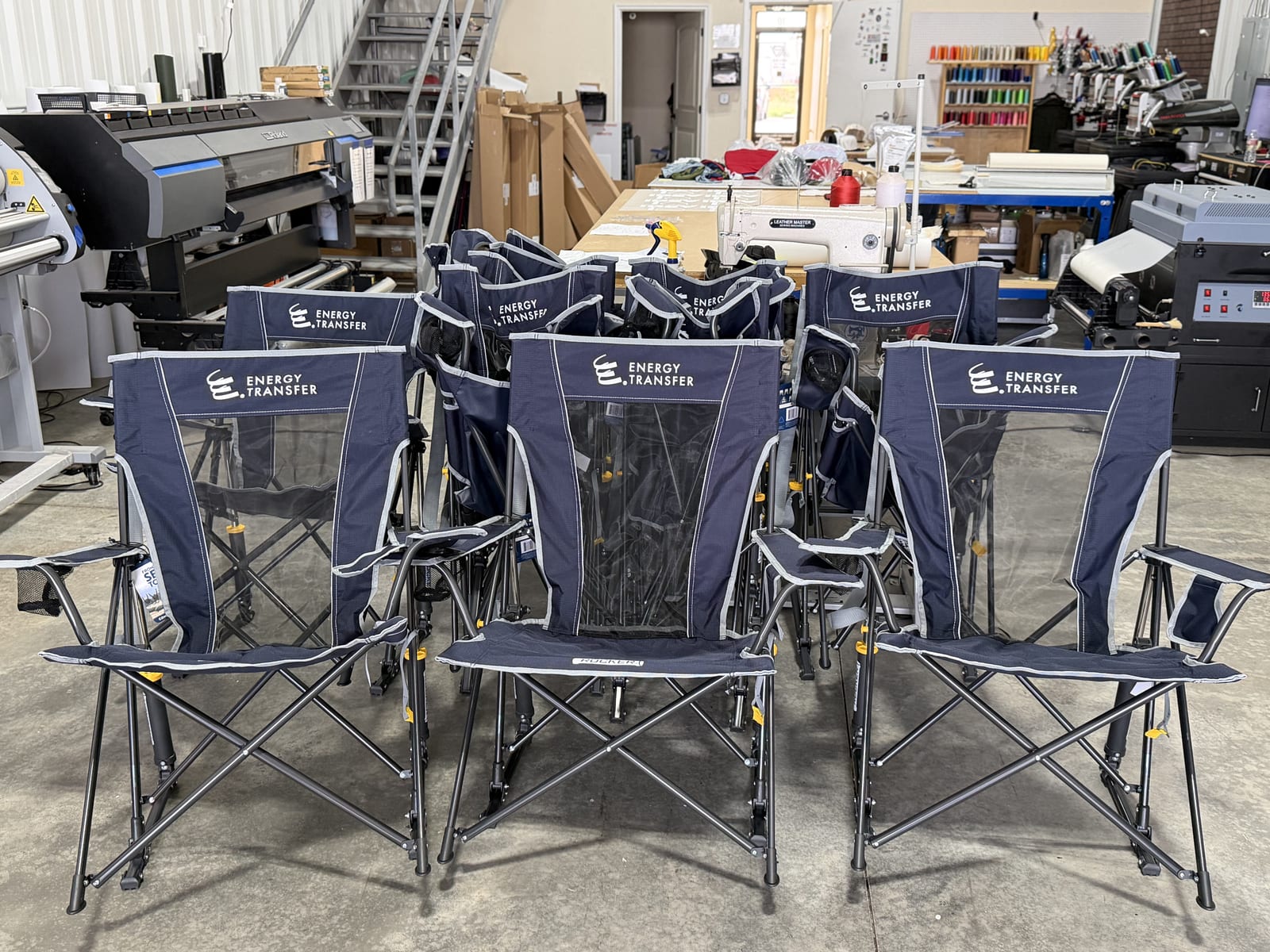 Rows of Energy Transfer branded camp chairs on the production floor