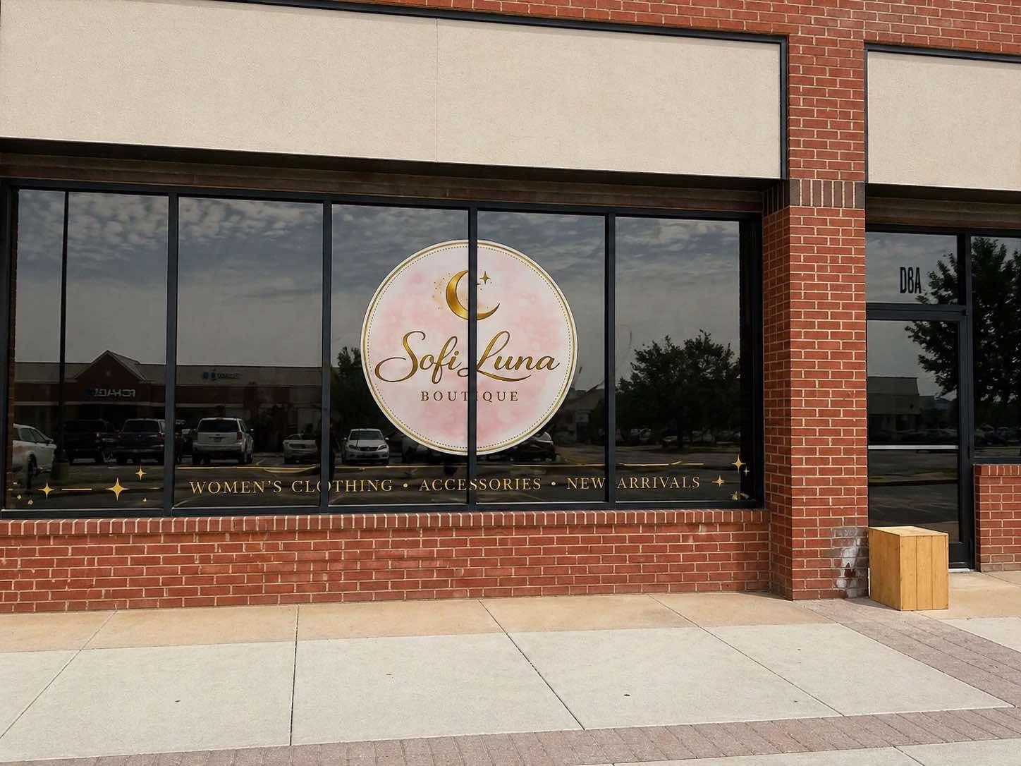 Storefront window graphics installed for a Midland boutique