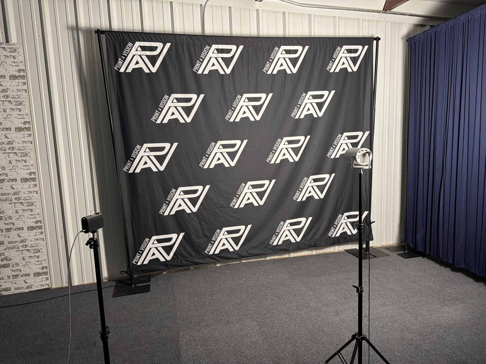 Step-and-repeat backdrop and lighting in the Press Play Studios media room