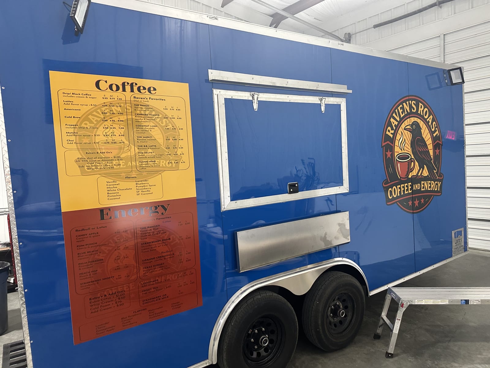Raven's Roast coffee trailer with printed menu panels and logo